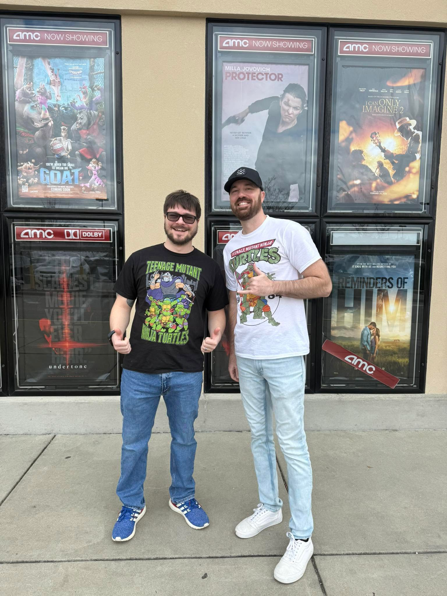 Corey and David outside a movie theater wearing Teenage Mutant Ninja Turtles shirts